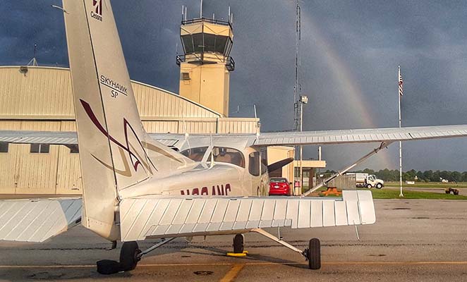 Plane with rainbow in background